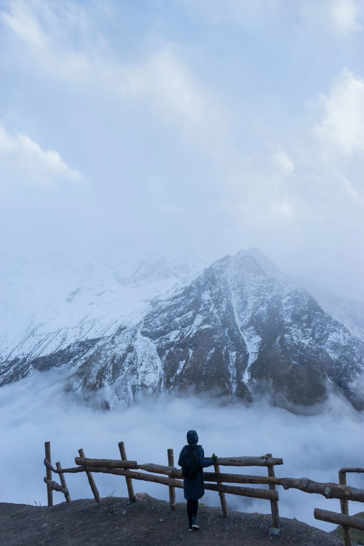 Figure Before Snowy Peaks